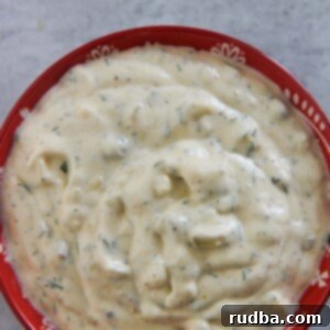 Zesty Seafood Sauce 2 Close-up of creamy homemade tartar sauce with fresh herbs.
