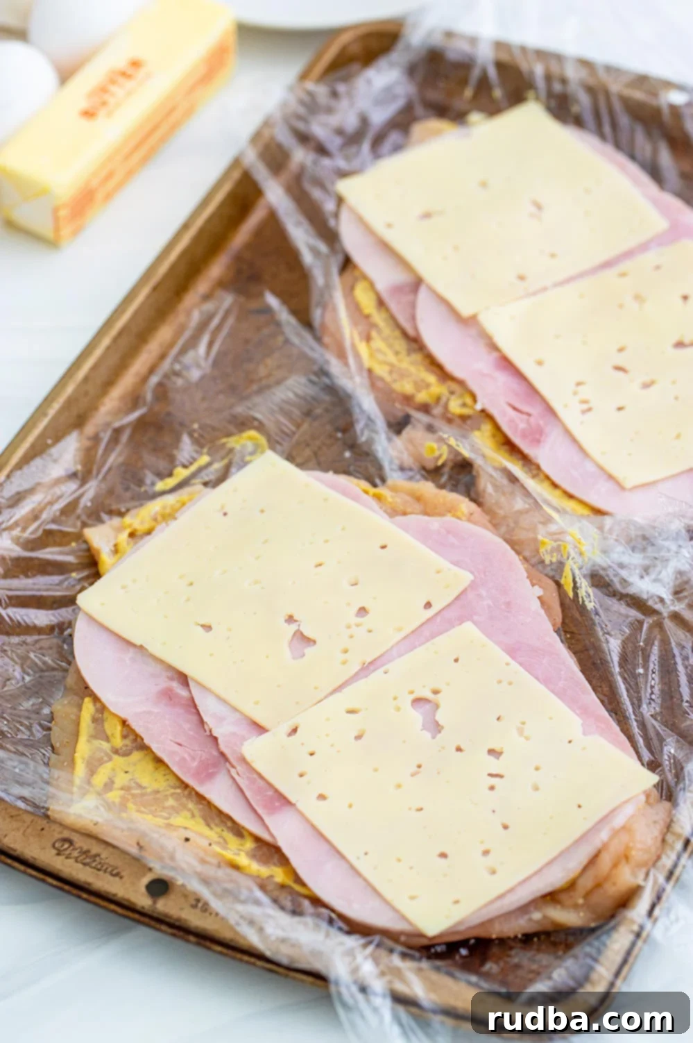 Raw chicken breasts ready to be pounded and stuffed for cordon bleu.