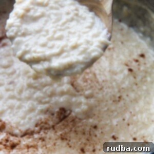 Rice Pudding 2 arroz con leche (rice pudding) in a large pot with a wooden spoon.