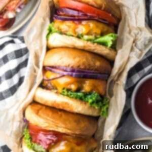 Homemade Classic Cheeseburger Perfection 2 Three classic cheeseburgers with lettuce, tomato, and onions.