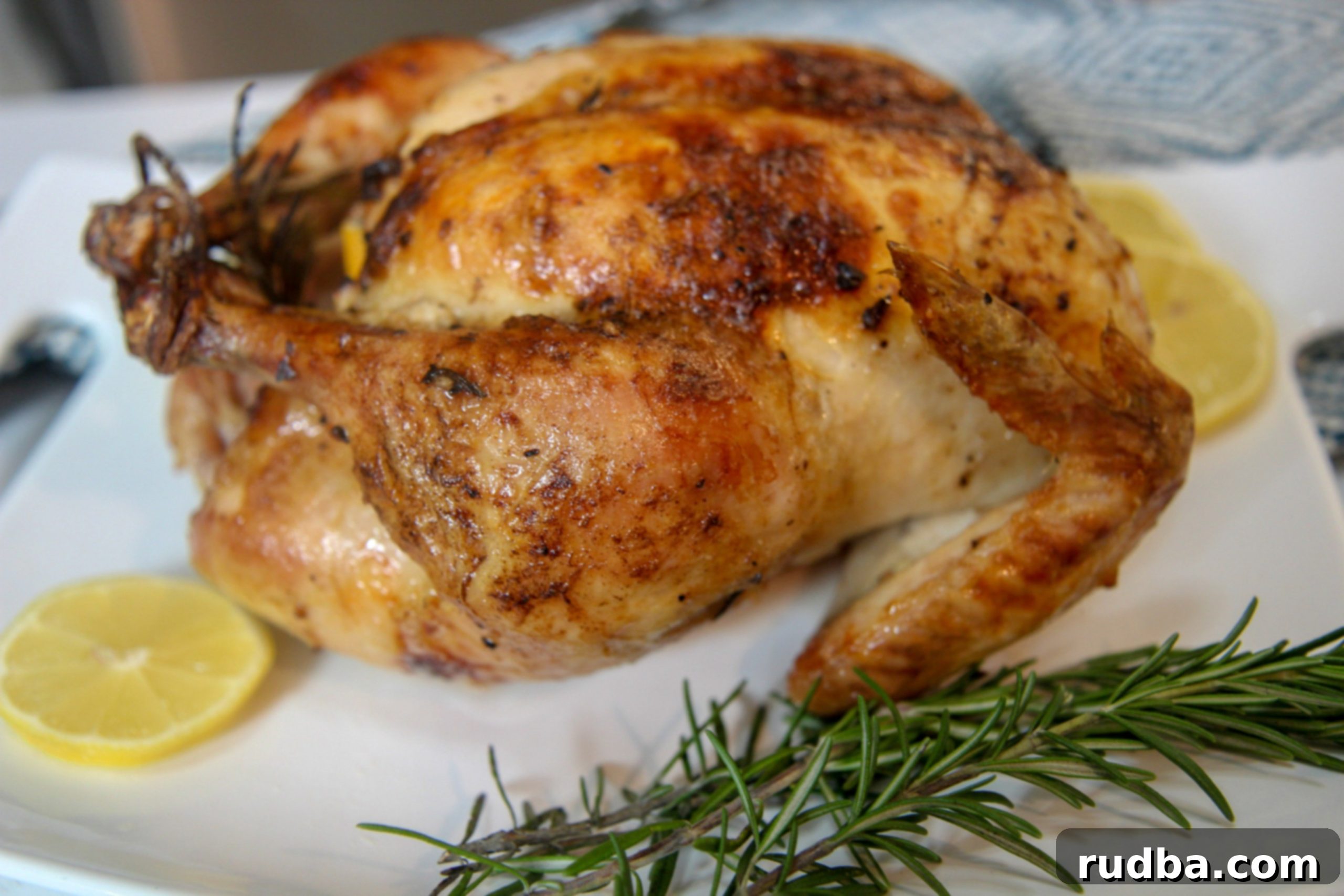 whole cooked chicken on a white platter