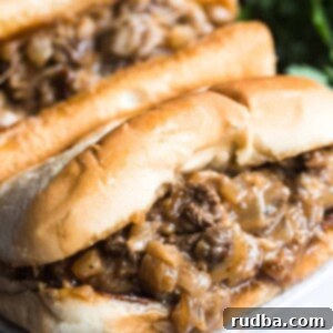 Ultimate Philly Cheesesteak 2 Two Philly cheesesteak sandwiches up close.