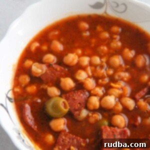 Garbanzo Stew 2 Garbanzos guisados in a white bowl up close.