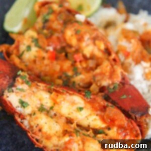 enchilado de langosta on a blue plate with rice and lime wedges.
