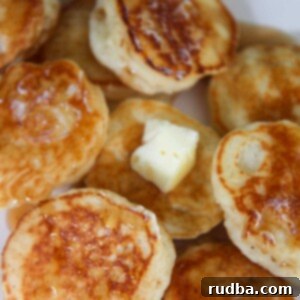 Granny's Little Dollar Delights 2 silver dollar pancakes with butter and syrup.