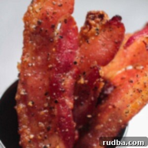 candied bacon strips in a cup.