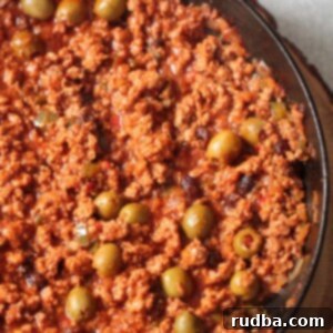 Spicy turkey picadillo in a skillet up close.