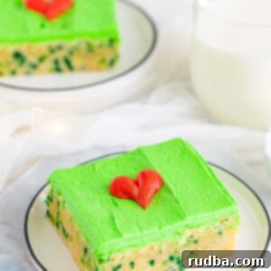 Grinchy Green Sugar Cookie Bars 2 Grinch sugar cookie bar with green frosting and a red heart.