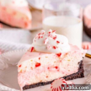 Peppermint No-Bake Bliss 2 A slice of no-bake peppermint cheesecake on a white plate.