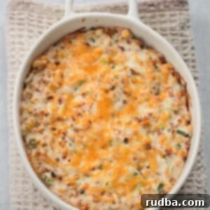 Creamy Hot Cheesy Corn Dip 2 hot cheesy corn dip in a white dish.