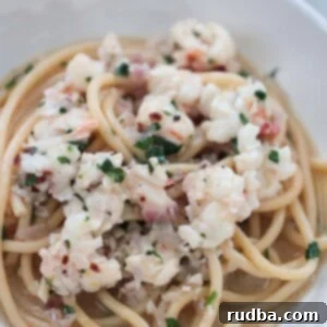 Regal Lobster Scampi 2 lobster scampi in a white bowl up close.