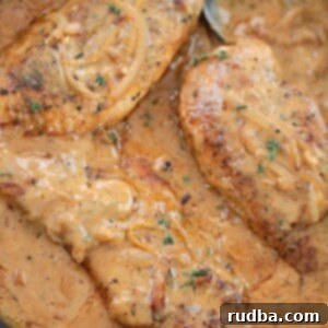 Velvet Chicken Breasts 2 Smothered chicken breasts in a skillet.