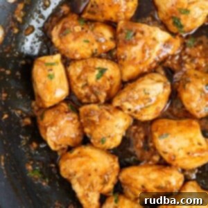 Sizzling garlic butter chicken bites in a cast iron skillet.