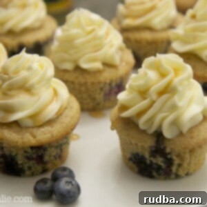 blueberry pancake cupcakes served on a white platter with fresh blueberries