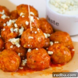 honey buffalo chicken meatballs with blue cheese crumbles on top.