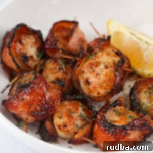 air fryer bbq bacon wrapped scallops with a lemon wedge.