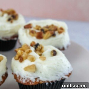 frosted carrot cake cupcakes with walnuts.