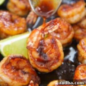 Irresistible Shrimp Creations 3 Honey chili lime shrimp up close with a spoon drizzling sauce on top.