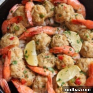 Irresistible Shrimp Creations 9 Crab stuffed shrimp in a cast iron skillet with lemon wedges and parsley