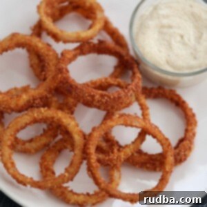 Crispy onion rings with spicy aioli on the side.