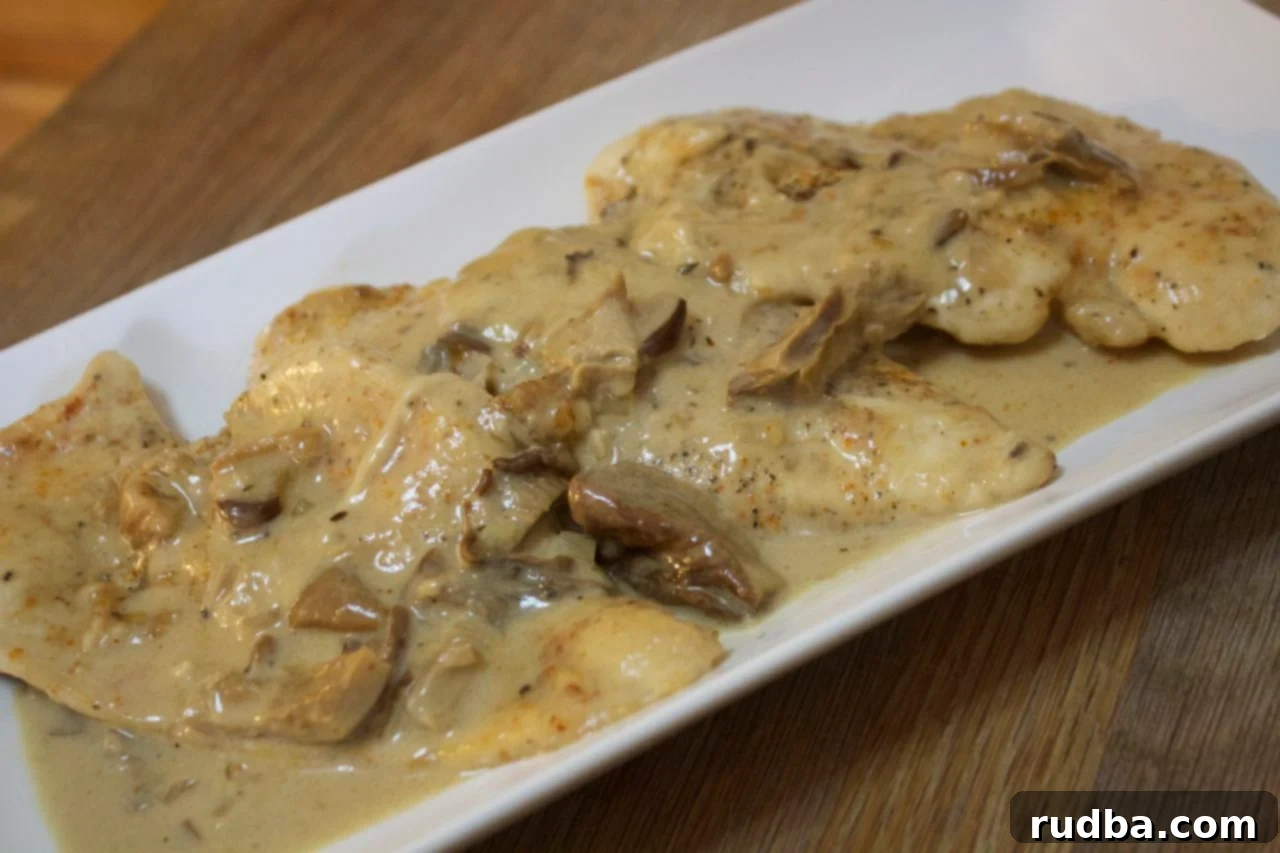 Delicious Creamy Mushroom Cheesy Chicken dish plated with sides
