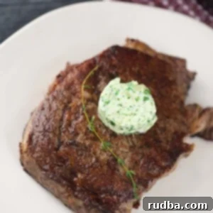 Skillet-Seared Ribeye Steak 2 pan-seared ribeye steak with butter and thyme on top.