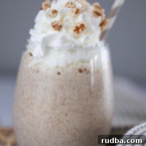 Batido de trigo with whipped cream and a straw.