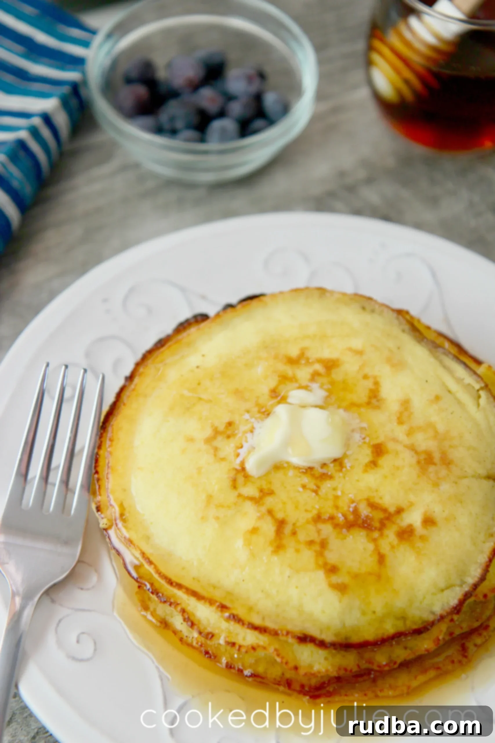 Keto-friendly low-carb pancakes with butter and syrup. Add blueberries for an extra garnish. 