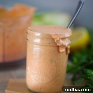 Zesty Remoulade 2 Homemade Louisiana Remoulade Sauce in a mason jar with a spoon.