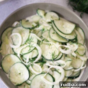 Creamy Cucumber Bliss 2 creamy cucumber salad in a bowl.