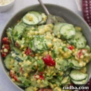 Refreshing Cucumber Avocado Tomato Salad 2 cucumber avocado tomato salad in a bowl with a spoon.