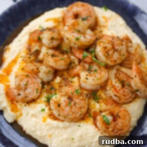 spicy shrimp and grits on a blue plate.