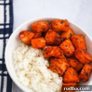 Spicy Honey Salmon Morsels 2 hot honey salmon bites with white rice on the side.