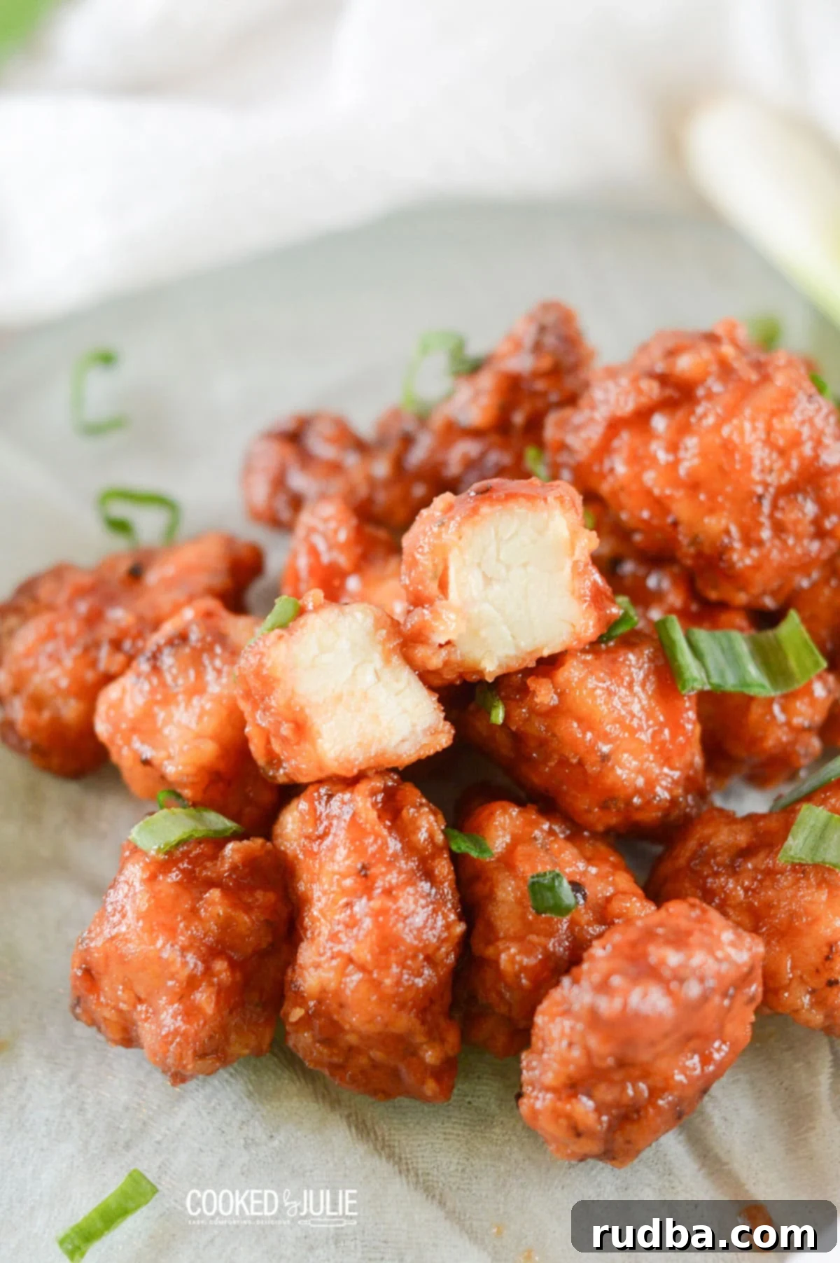 honey boneless bbq wings with scallions on a green plate