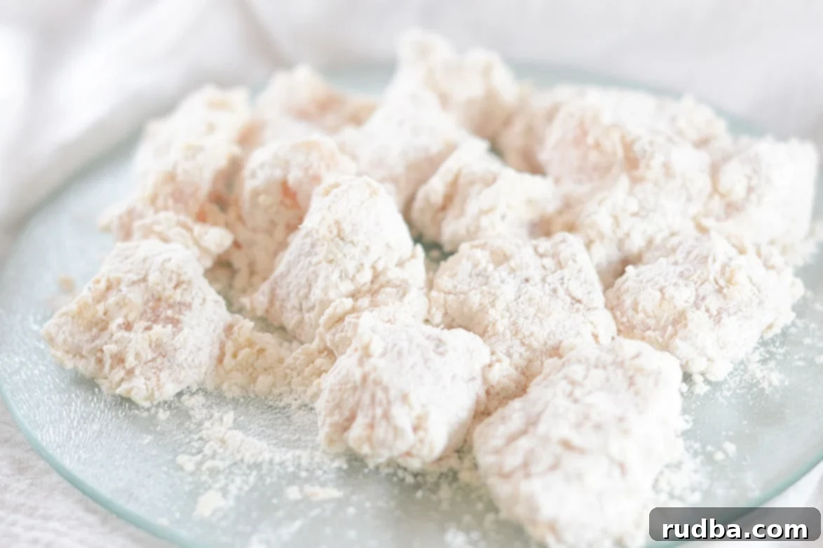 chicken coated in flour on a plate 