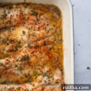 Oven-Baked Tilapia Delight 2 baked tilapia in a baking dish.