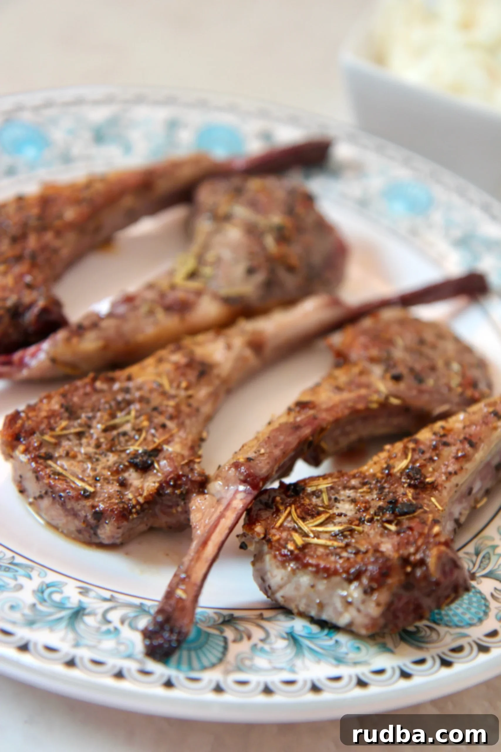 Perfectly seared lamb chops seasoned with garlic and rosemary, ready to be served.