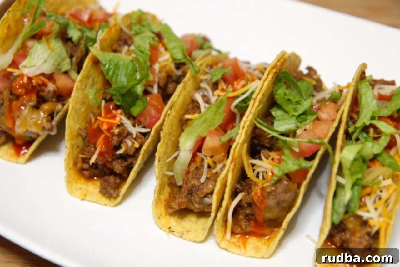 Crispy shell beef tacos with cheese, tomatoes and lettuce. 