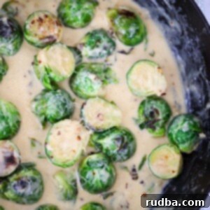 Velvety Garlic Brussels Sprouts 2 Creamy garlic brussels sprouts in a skillet up close.