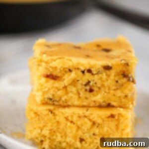 Decadent Caramelized Onion Cornbread 2 two slices of caramelized onion cornbread on a plate.
