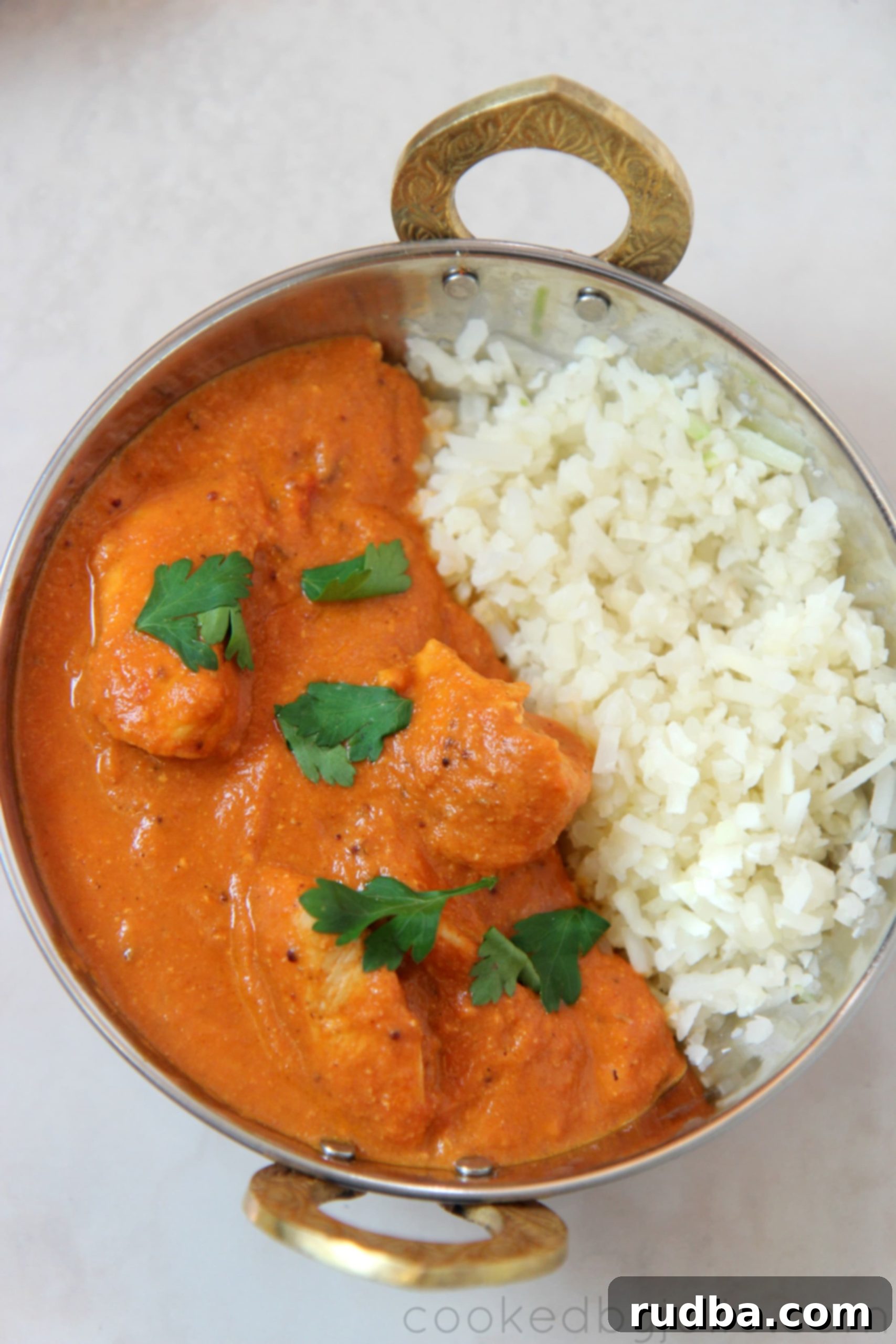 Keto butter chicken served in a delicious low carb tomato sauce with cauliflower rice on the side