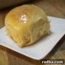 Tropical Cloud Rolls 3 Freshly baked Hawaiian sweet rolls, golden brown and fluffy.