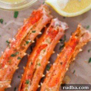 Oven Baked King Crab Legs 2 baked king crab legs with butter and lemon on the side.