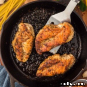 Perfectly Pan-Seared Chicken Breasts 2 three pan seared chicken breasts in a cast iron skillet.