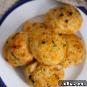 Irresistible Red Lobster Cheddar Biscuits 2 six red lobster cheddar biscuits on a white and blue plate.