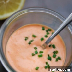 Irresistible Bang Bang Sauce 2 Homemade Bang Bang Sauce in a clear glass jar.