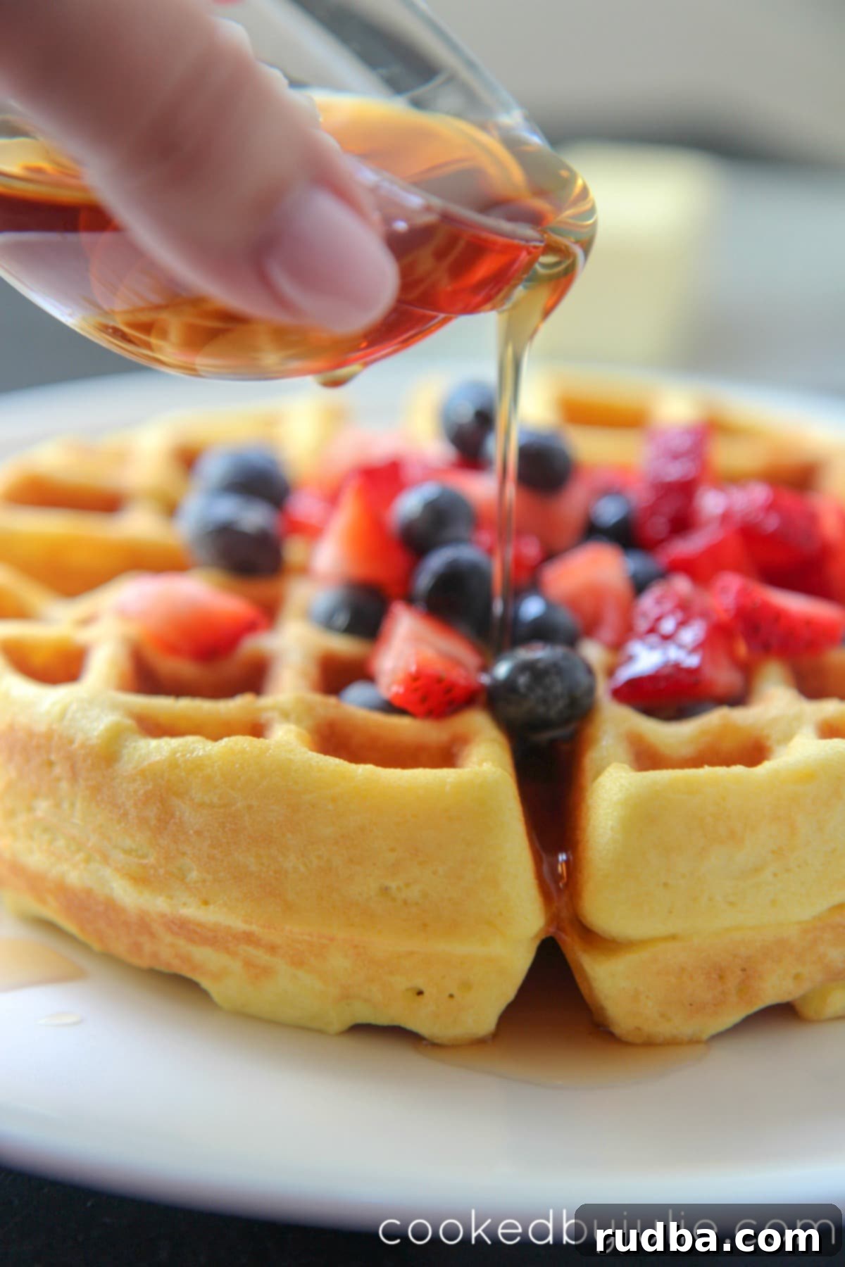 Delicious Keto waffles with melted butter, sugar-free syrup, and fresh mixed berries