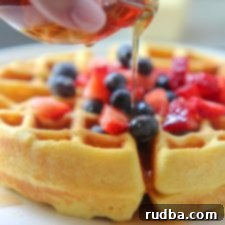Fluffy Keto Waffles 6 Close up of Keto waffles with syrup and fresh berries in a round dish