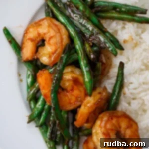honey shrimp and green beans with white rice on the side.