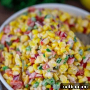 Luscious Creamy Corn Salad 2 creamy corn salad in a white bowl.